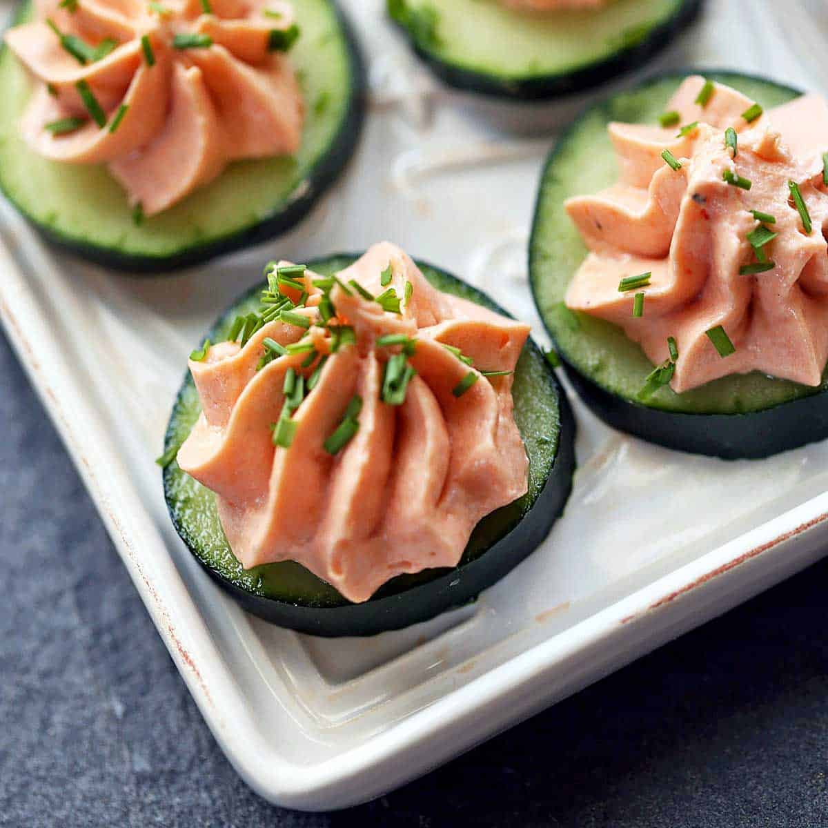 Salmon mousse is served on top of cucumber slices.