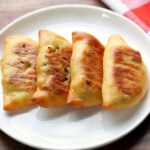 Keto empanadas are served on a white plate with a napkin.
