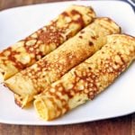 Pannenkoeken are served on a white plate.