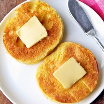 Keto English muffin is topped with butter.