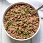 Chopped liver is served in a bowl with a spoon.