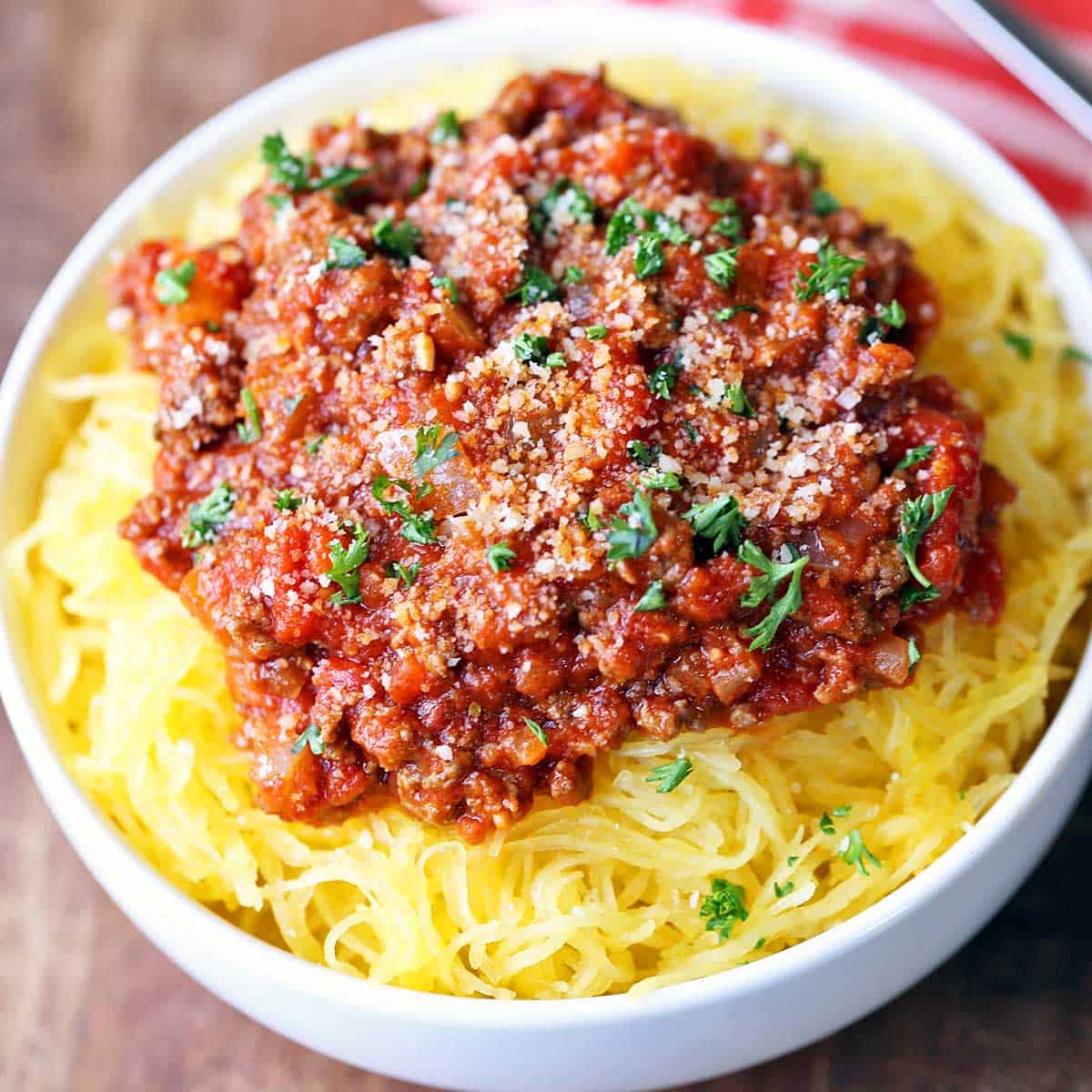 Spaghetti squash with meat sauce is served in a white bowl.