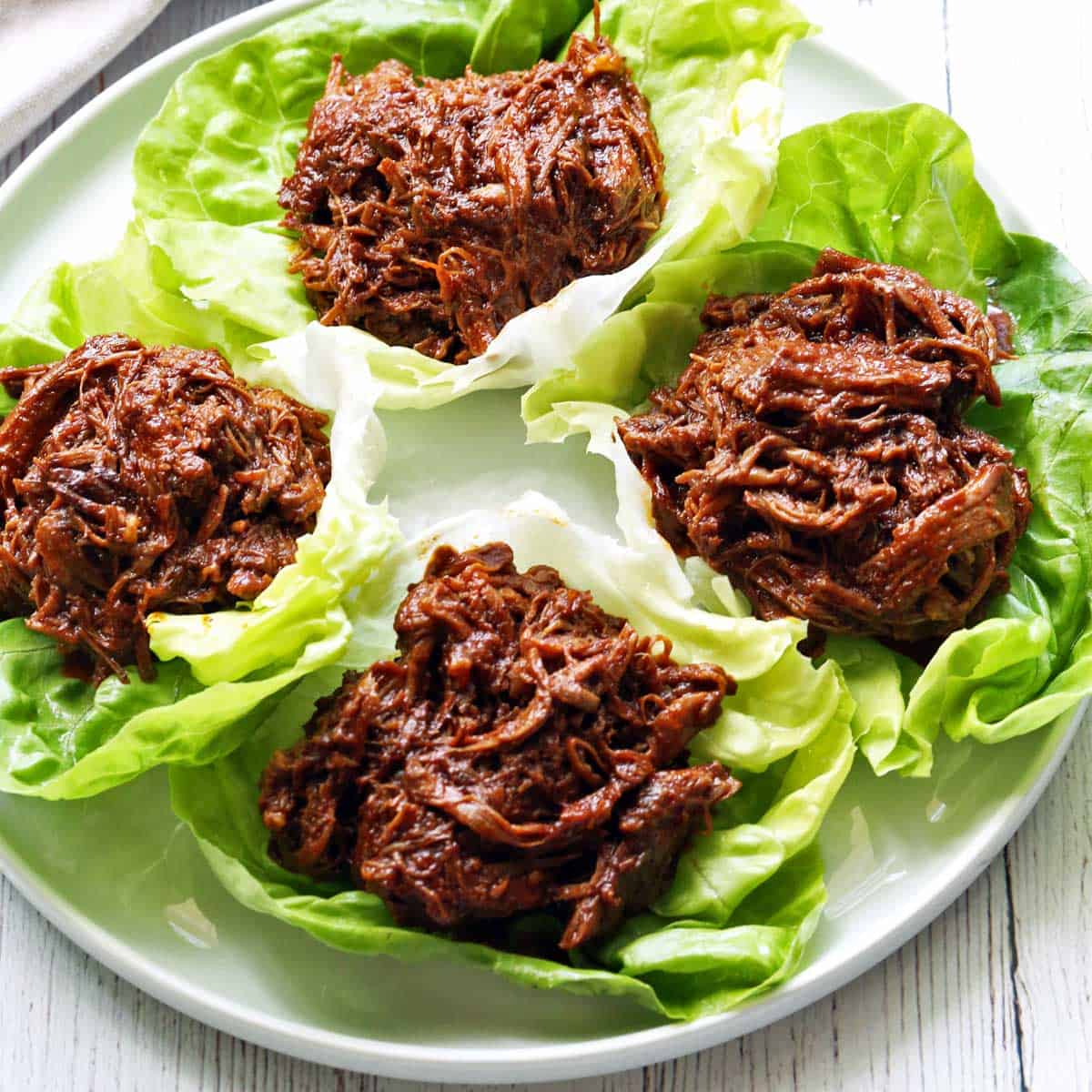 Pulled beef is served in lettuce cups.