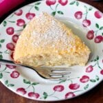 Keto coconut cake is served on a plate with a fork.