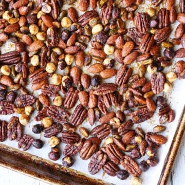 Honey-roasted nuts are served on a baking sheet.