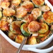 Zucchini casserole is served in a white baking dish.