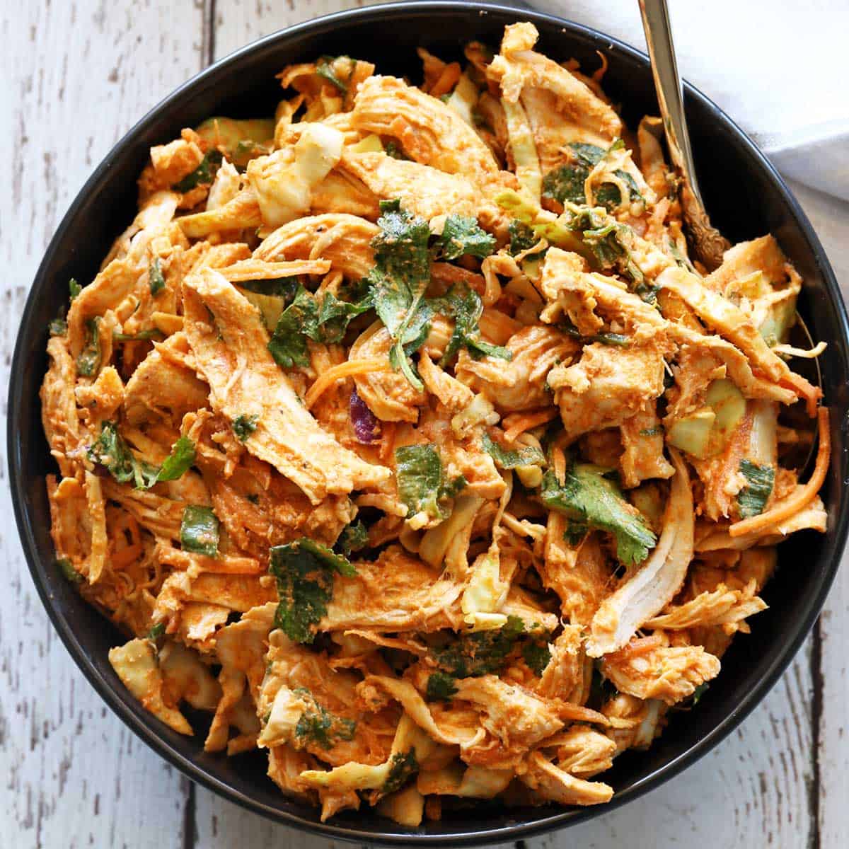 Thai chicken salad is served in a bowl.