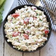 Chicken salad is served in a dark bowl.