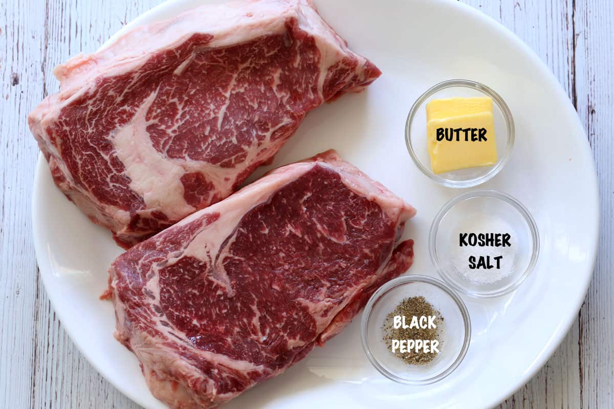 The ingredients needed to cook ribeye steak.