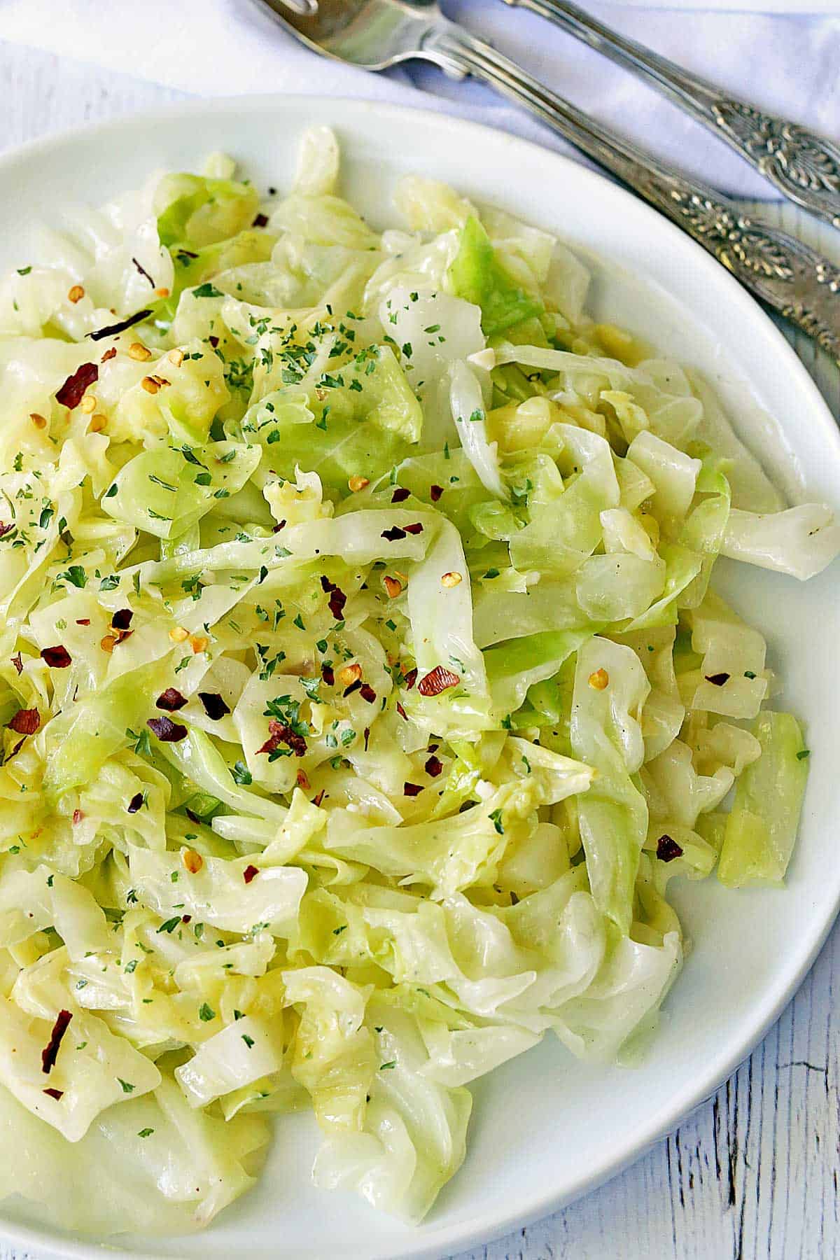 Steamed cabbage is served on a plate.
