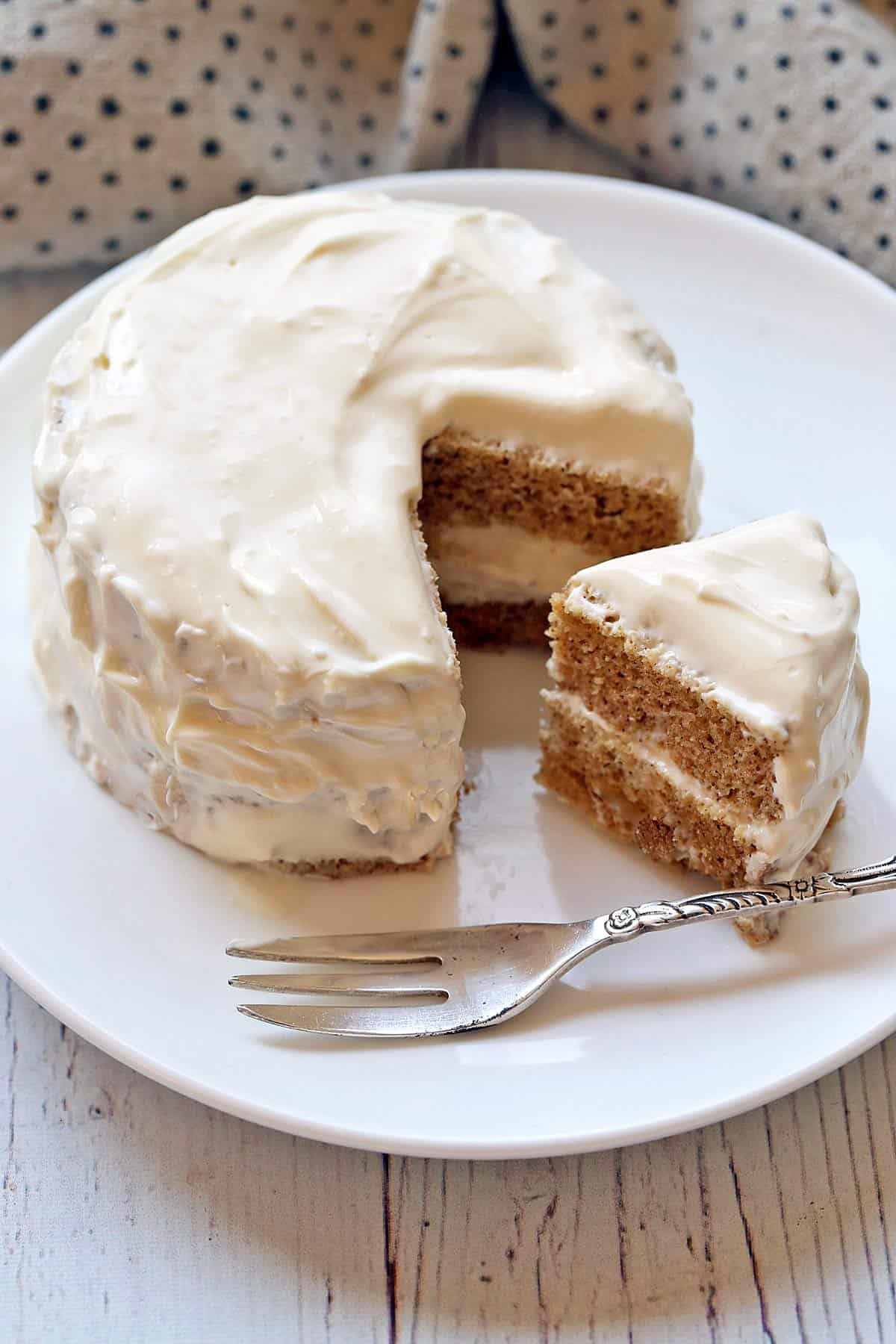 Keto mug cake is served on a white plate with a small cake fork. 