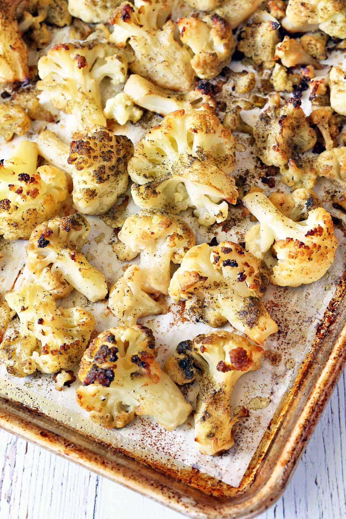 Roasted frozen cauliflower is served on a baking sheet. 