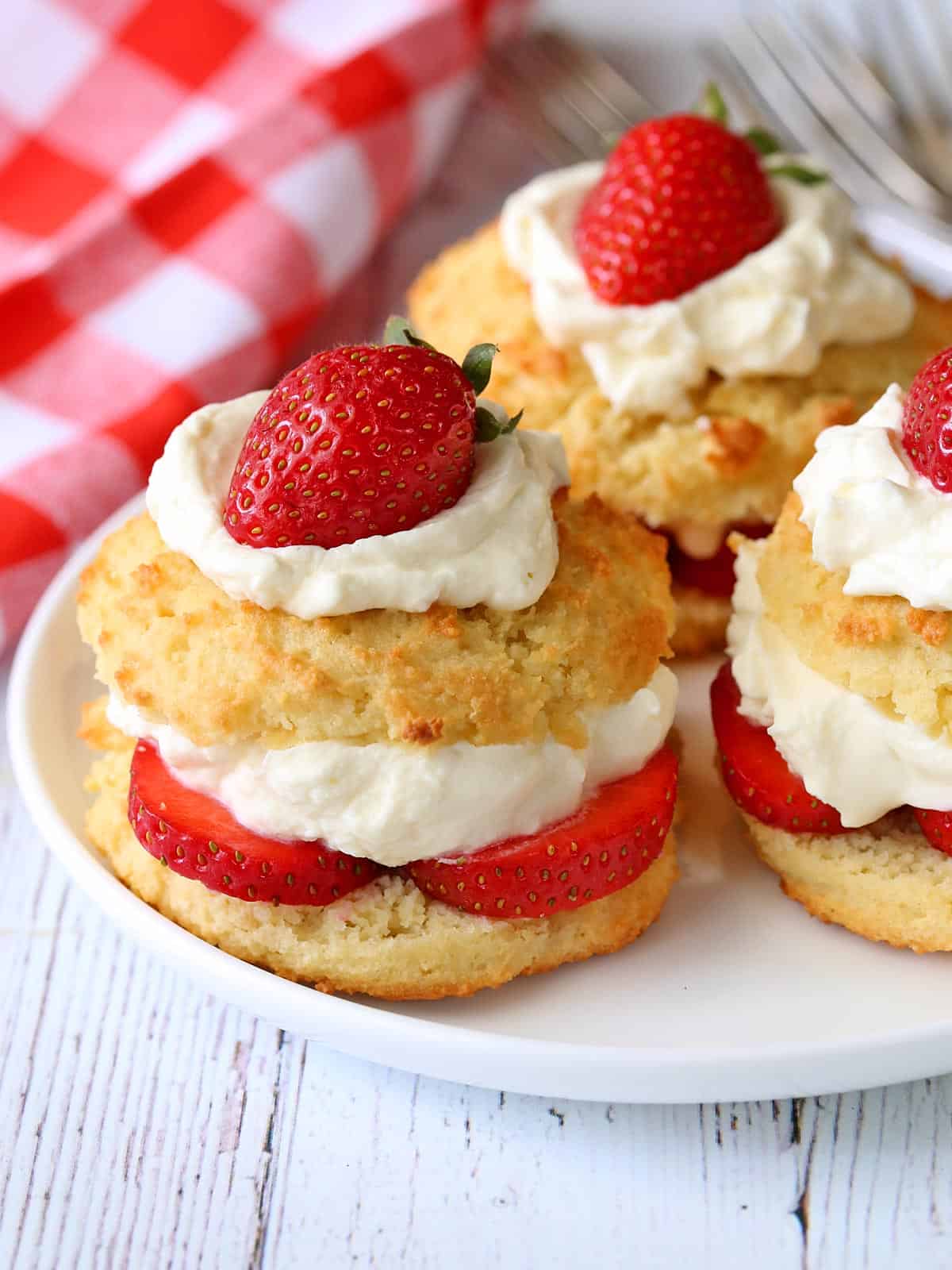 Keto strawberry shortcake is served on a white plate. 