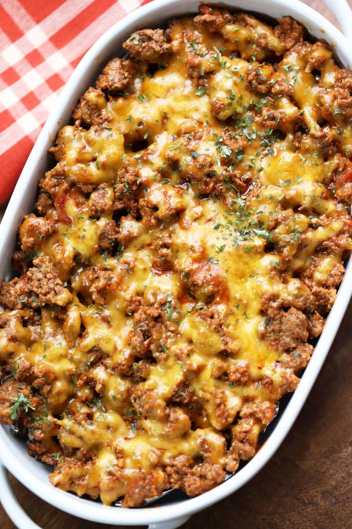 Cheeseburger casserole is served in a white oval baking dish.