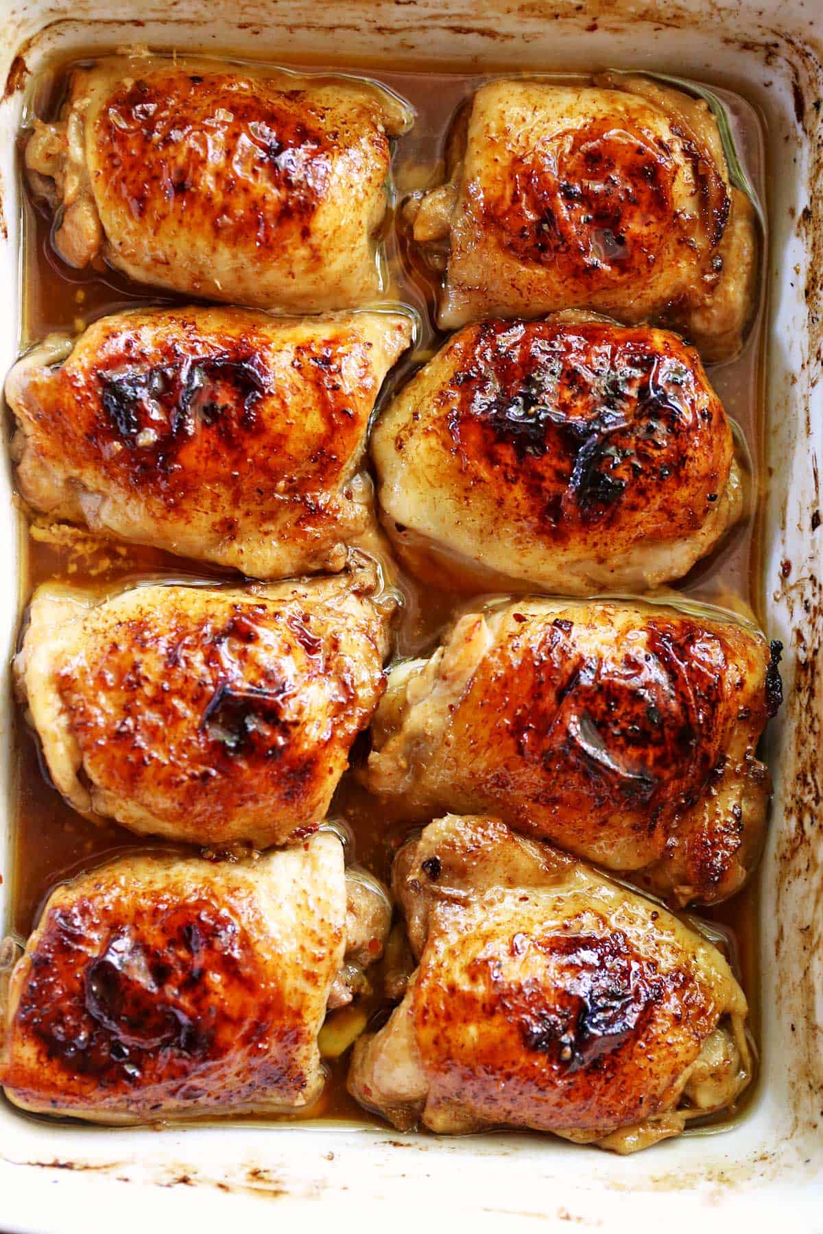 Baked soy sauce chicken is served in a white baking dish. 