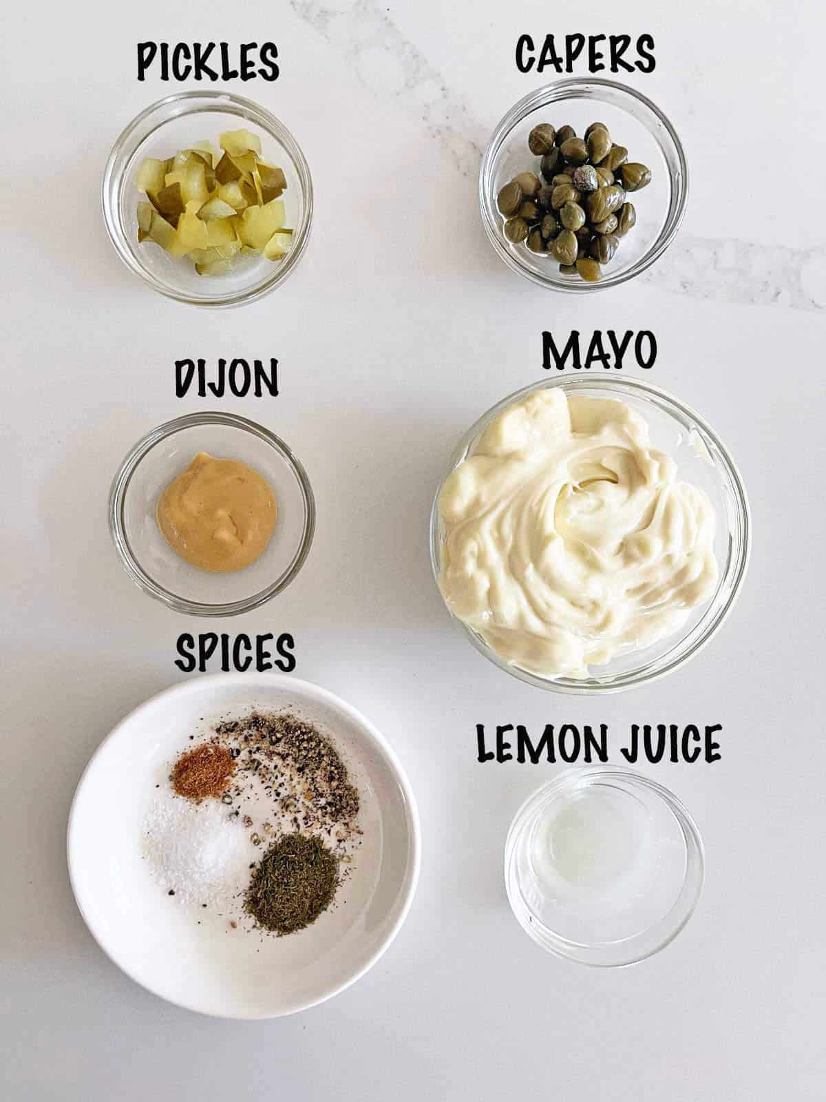 The ingredients needed to make a homemade tartar sauce.
