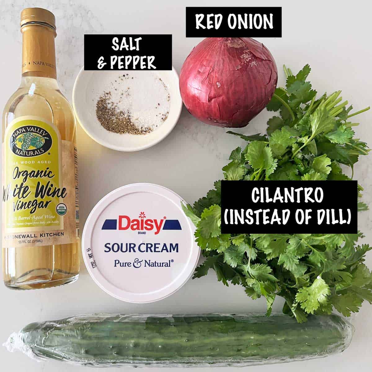 The ingredients needed to make a creamy cucumber salad.