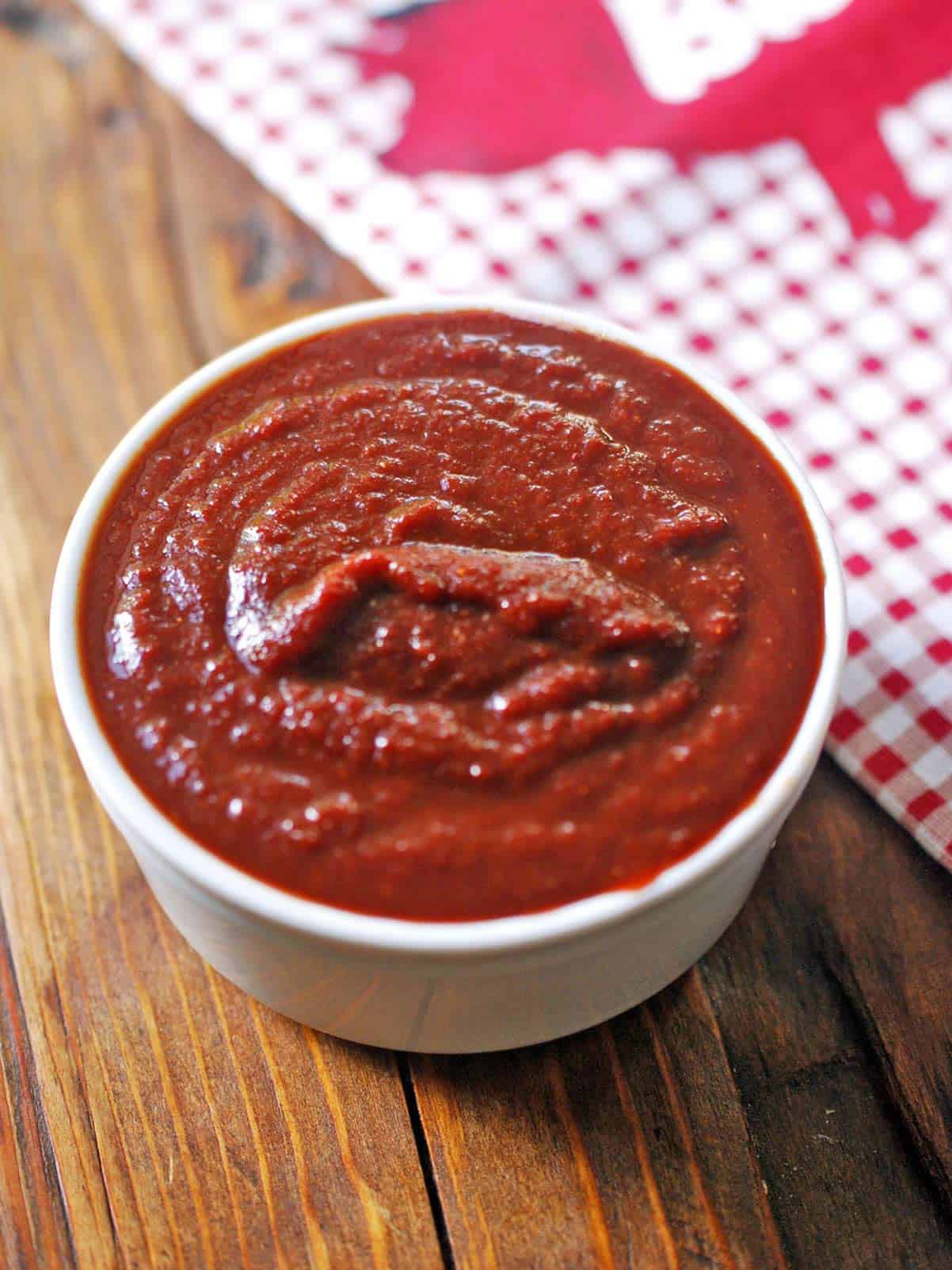 Sugar free BBQ sauce is served in a white bowl. 