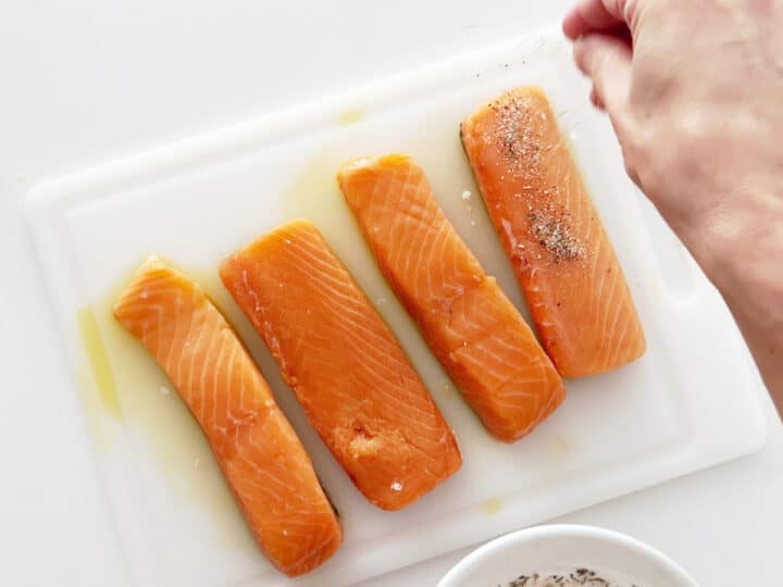 Seasoning the salmon with spices.