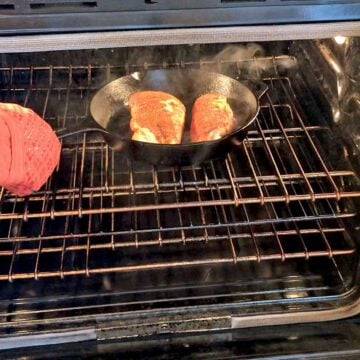Placing blackened chicken in the oven.
