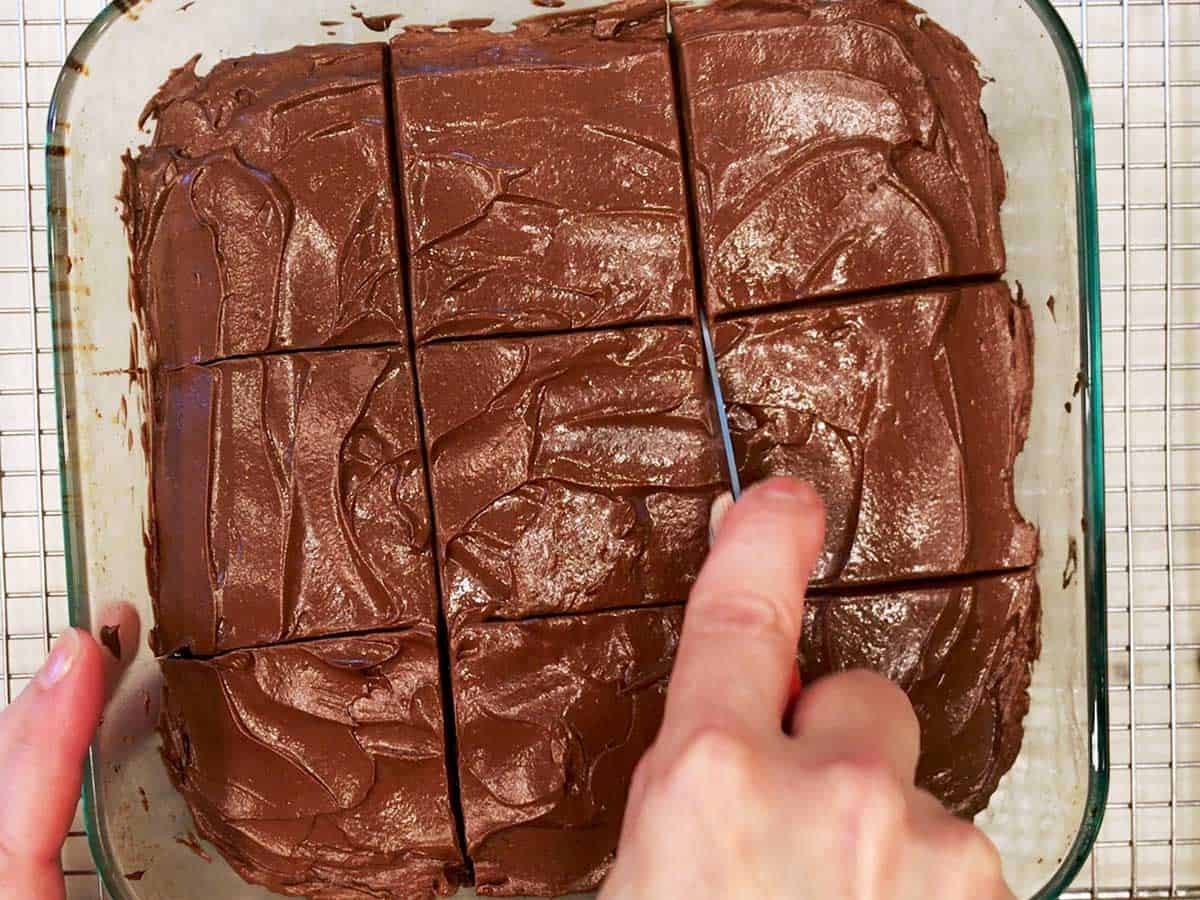 Cutting the cake into nine squares.