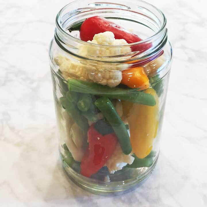 Placing the vegetables in a jar.