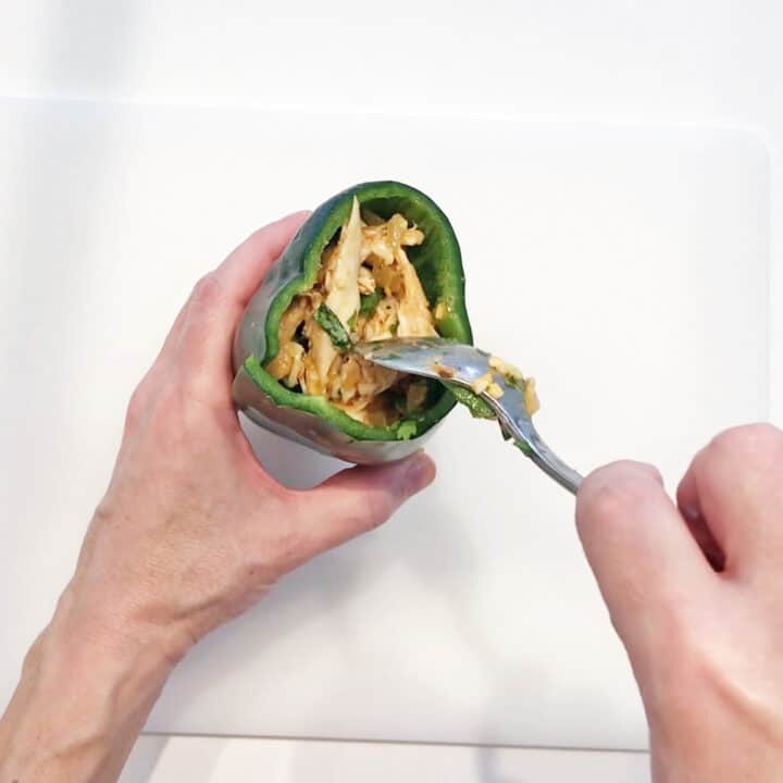 Stuffing the filling into the poblano peppers.