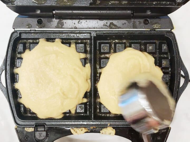 Adding the batter to the waffle maker.