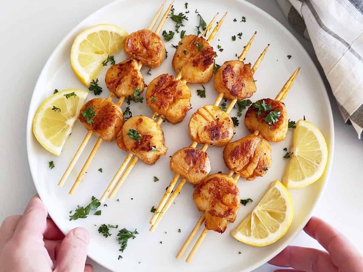 Serving the scallops.