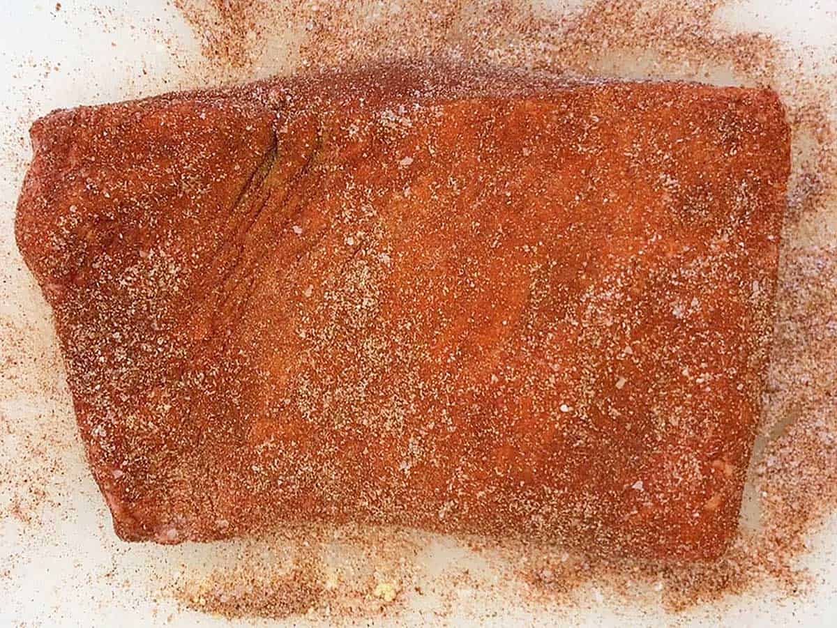 Raw brisket coated in spices.