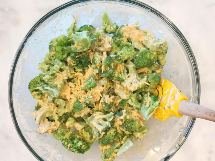 Mixing the broccoli and the creamy sauce.