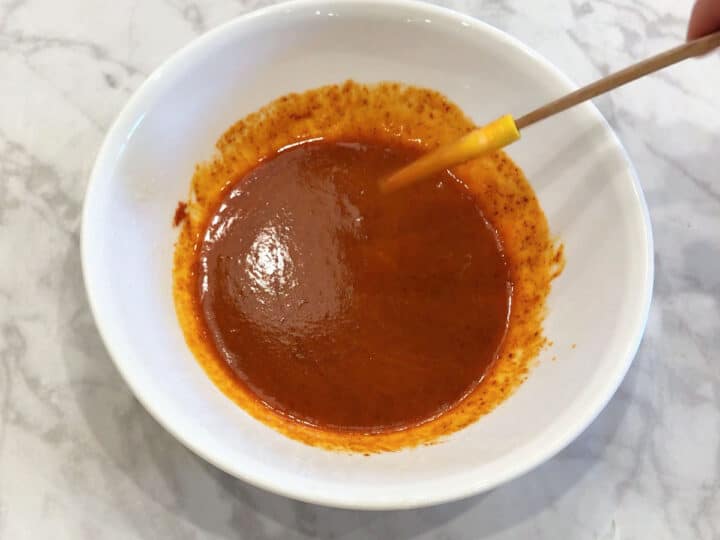 Mixing buffalo sauce.