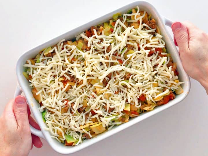 Cabbage casserole in a baking dish ready for the oven.