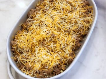 Cheeseburger casserole mixture is ready for baking in the baking dish.