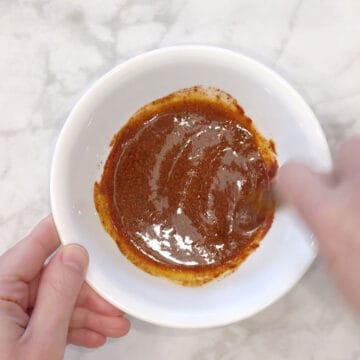 Seasoning mix for drumsticks is being mixed.