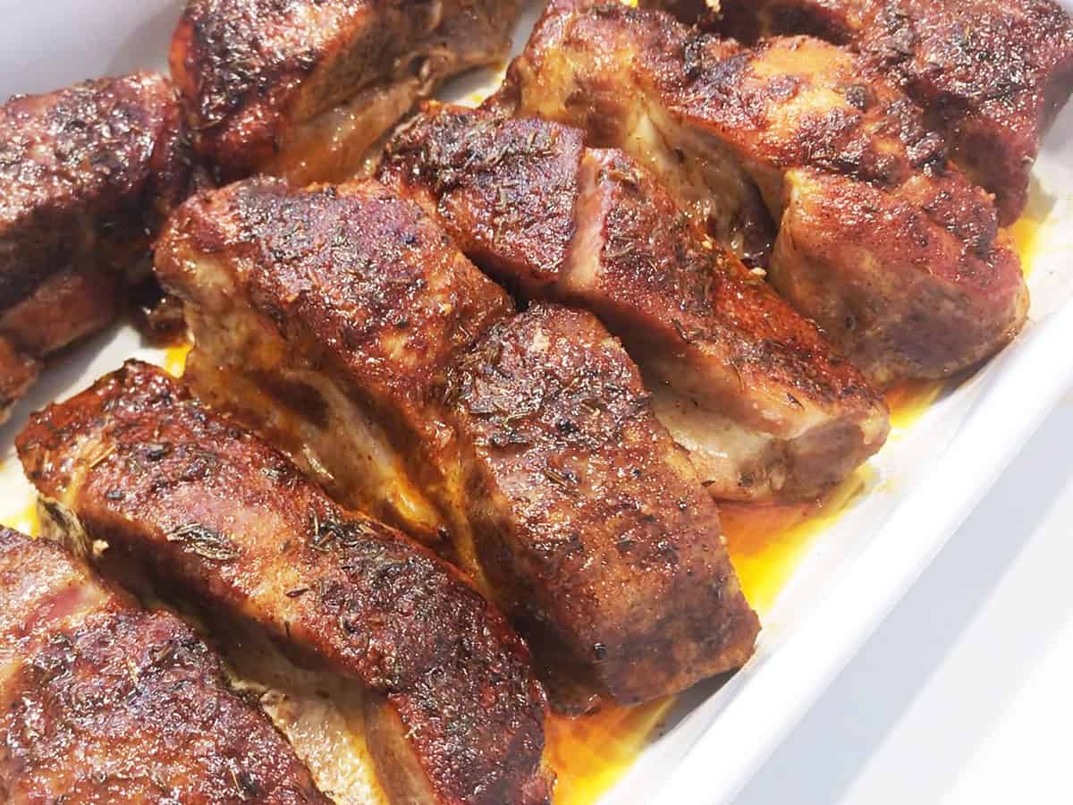 Fully cooked country-style ribs in a pan, ready to be served.