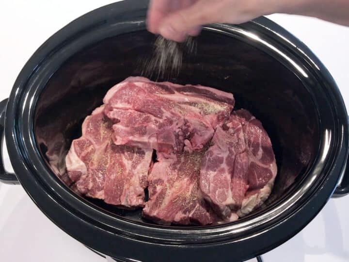 Seasoning the chops with spices.