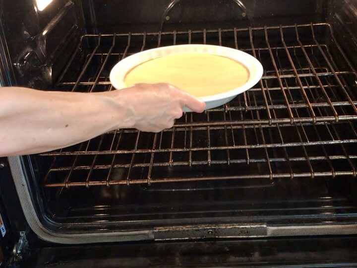 Placing the cake in the oven.