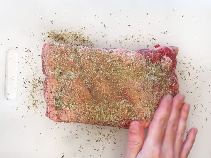 Seasoning ribeye roast.
