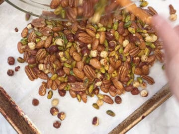 Transfer the seasoned nuts to the pan.