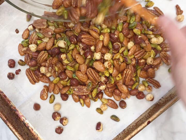 Transfer the seasoned nuts to the pan.