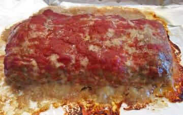Fully cooked meatloaf on a baking sheet.