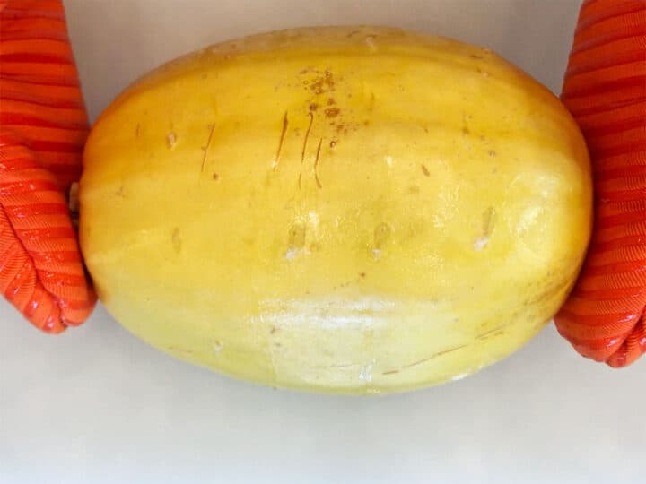 Removing the squash from the microwave.