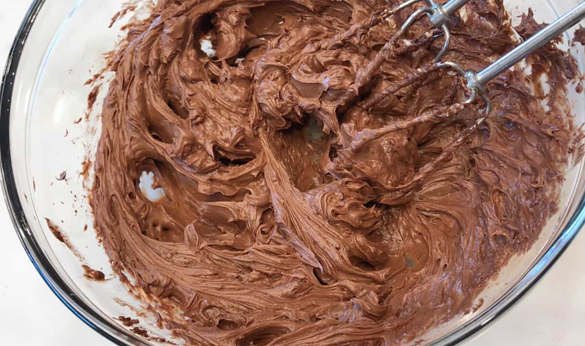Mixing the frosting in a bowl.