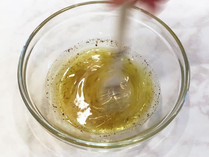Mixing the dressing in a small bowl.