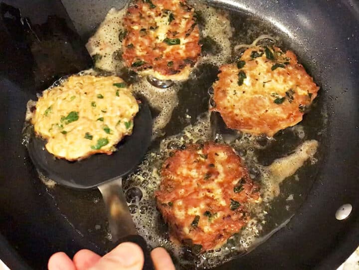 Flipping tuna patties in the skillet.