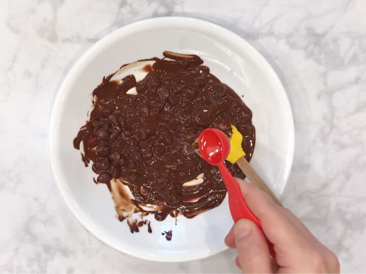 Adding oil to the melted chocolate.