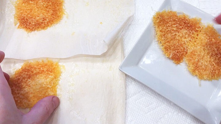 Removing cheese crackers from the parchment paper.