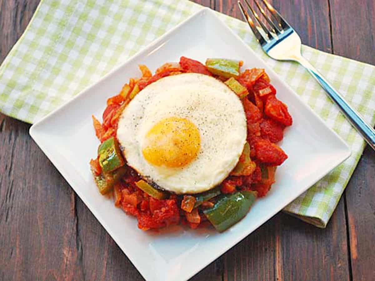 Serving leftover shakshuka with a freshly fried egg.
