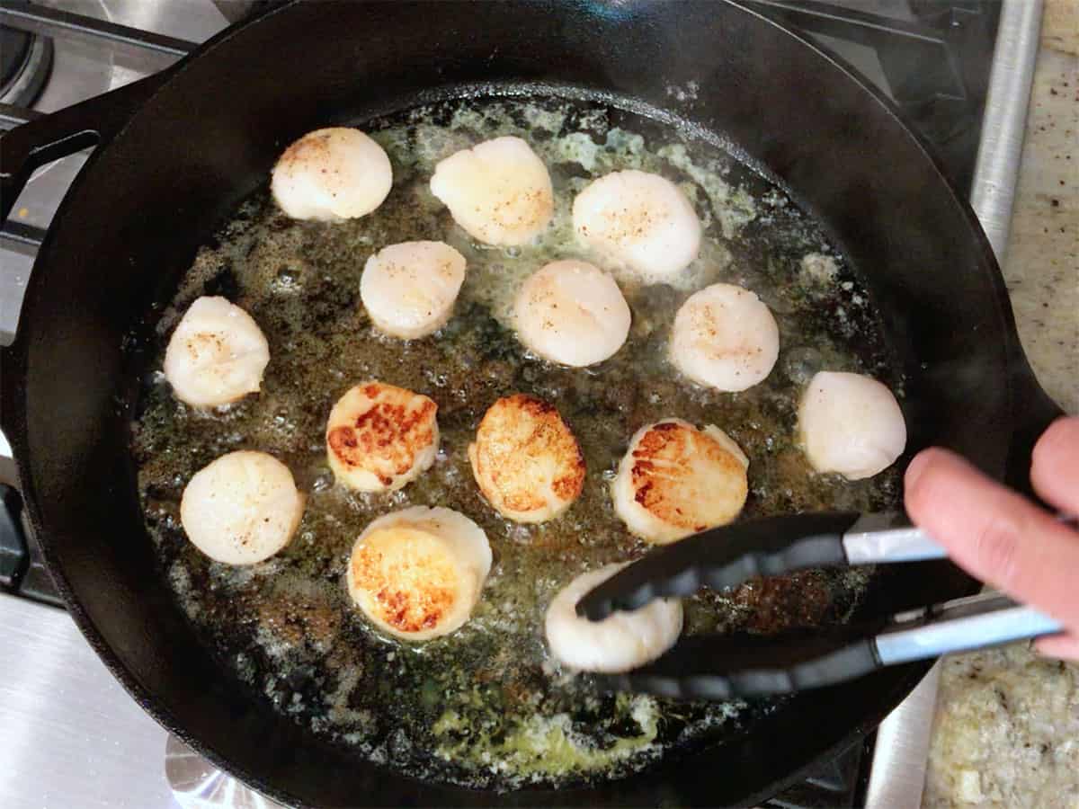 Flipping the scallops.